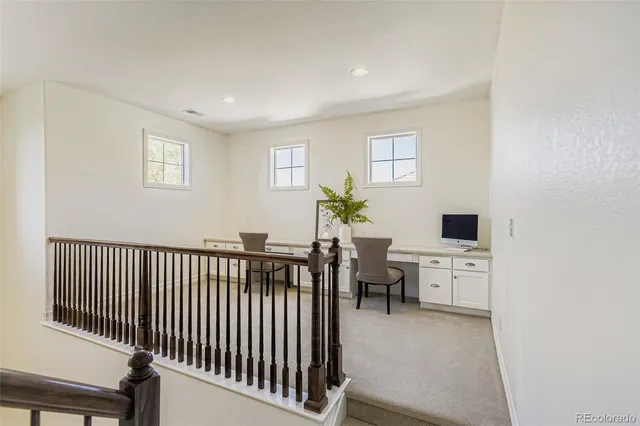 a living room with furniture a flat screen tv and a window
