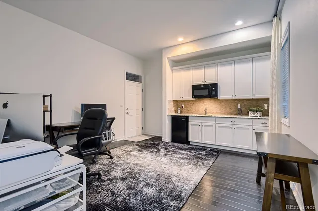 a kitchen with a stove a sink and a refrigerator