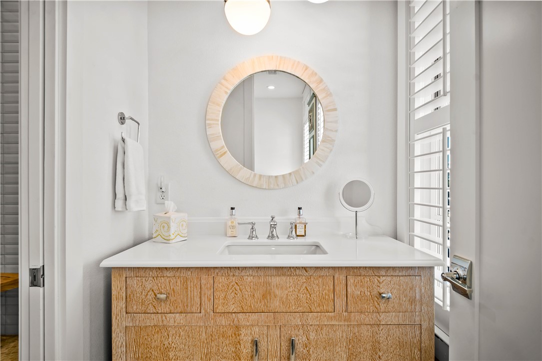 200 Round Road Port Aransas, TX 78373 - Photo 14 of 38 a bathroom with a sink and a mirror