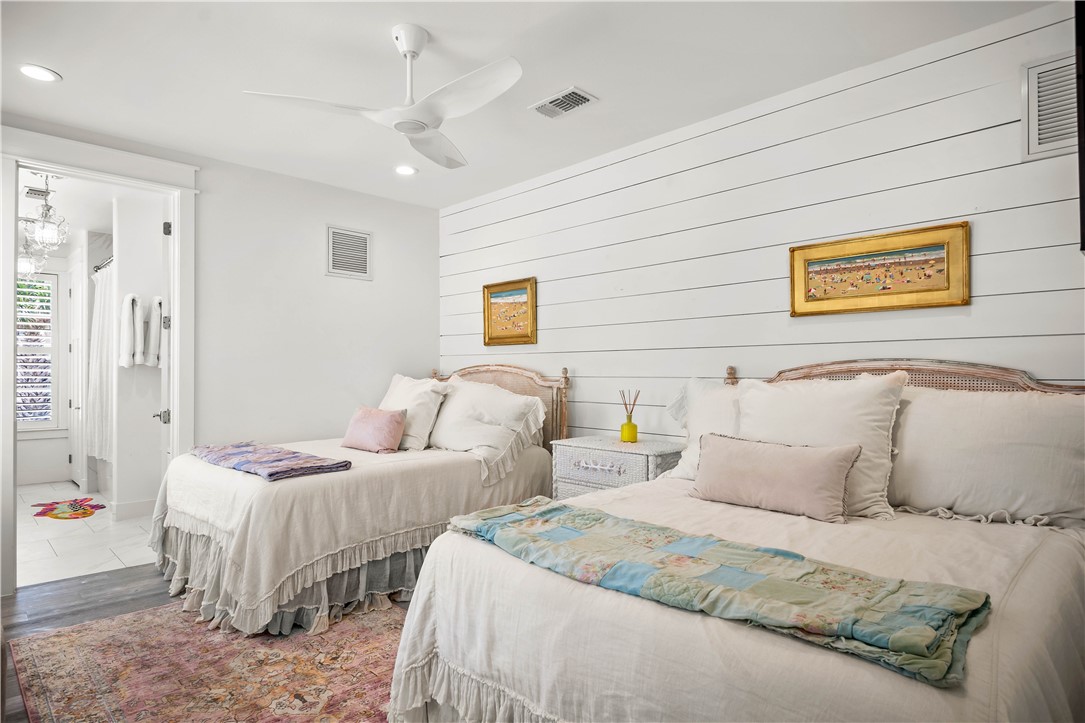 200 Round Road Port Aransas, TX 78373 - Photo 16 of 38 a bedroom with two beds and painting on the wall