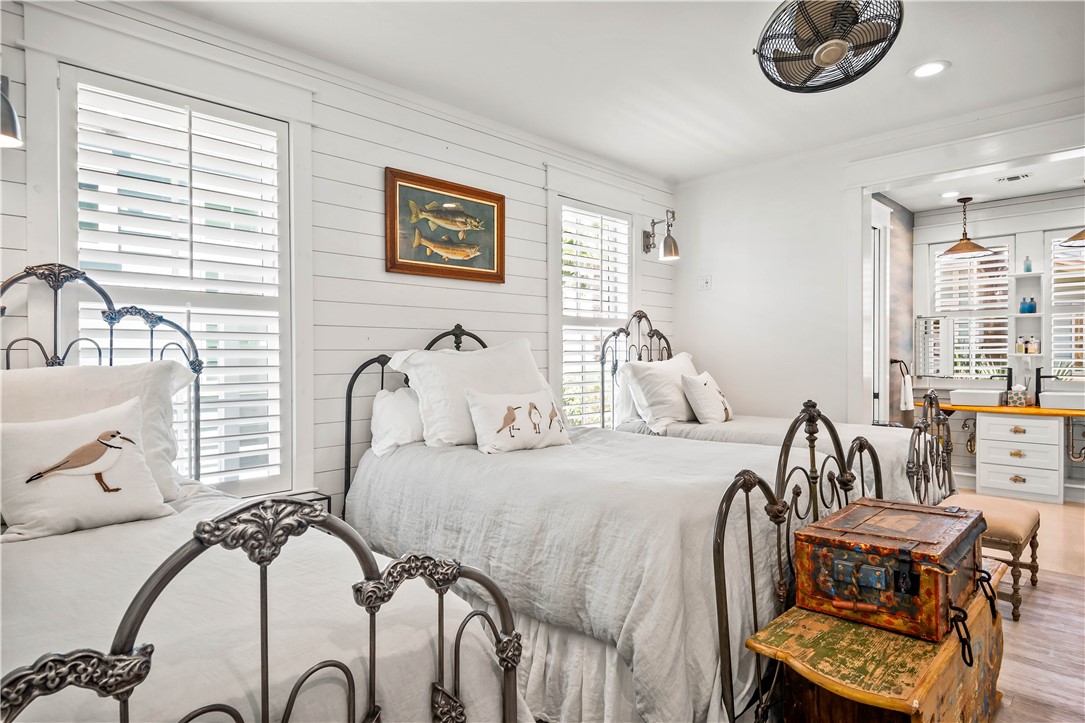 200 Round Road Port Aransas, TX 78373 - Photo 21 of 38 a bedroom with furniture and a large window