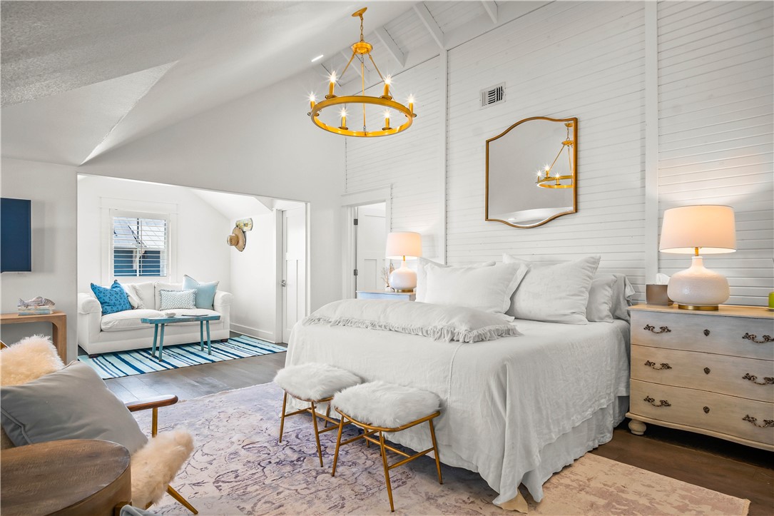 200 Round Road Port Aransas, TX 78373 - Photo 24 of 38 a bedroom with a bed and a chandelier