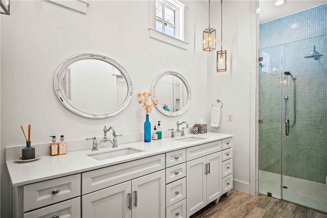 200 Round Road Port Aransas, TX 78373 - Photo 26 of 38 a bathroom with a double vanity sink and a mirror
