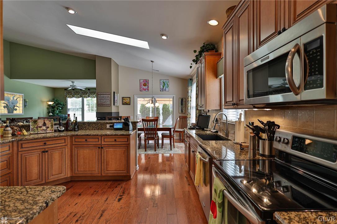 1015 Declaration Drive Bethlehem, PA 18017 - Photo 14 of 33 a kitchen with stainless steel appliances granite countertop a stove top oven a sink dishwasher and cabinets with wooden floor
