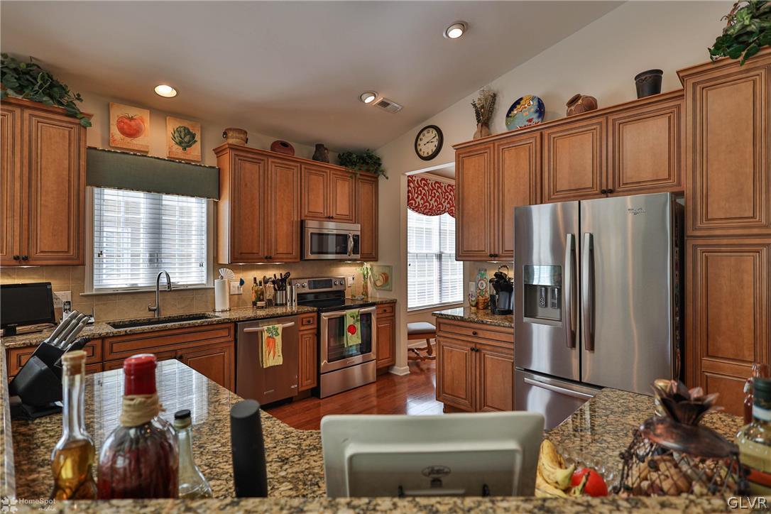 1015 Declaration Drive Bethlehem, PA 18017 - Photo 19 of 33 a kitchen with stainless steel appliances granite countertop a sink stove and refrigerator
