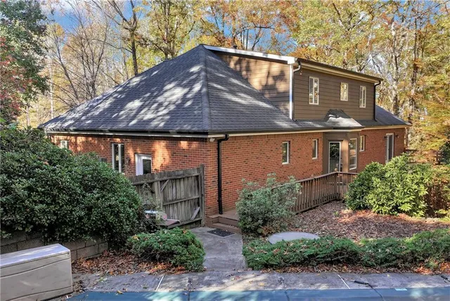 a view of staircase with lots of frames on wall and wooden floor