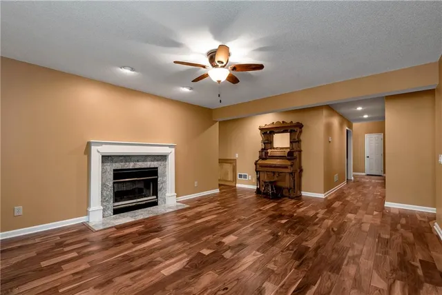a view of a balcony with wooden floor and large trees