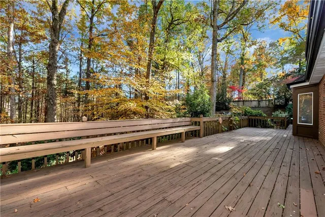 a kitchen with granite countertop white cabinets and refrigerator