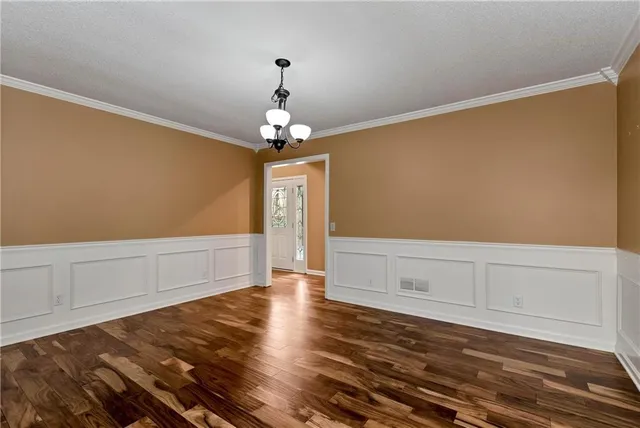 a bedroom with a bed and large windows