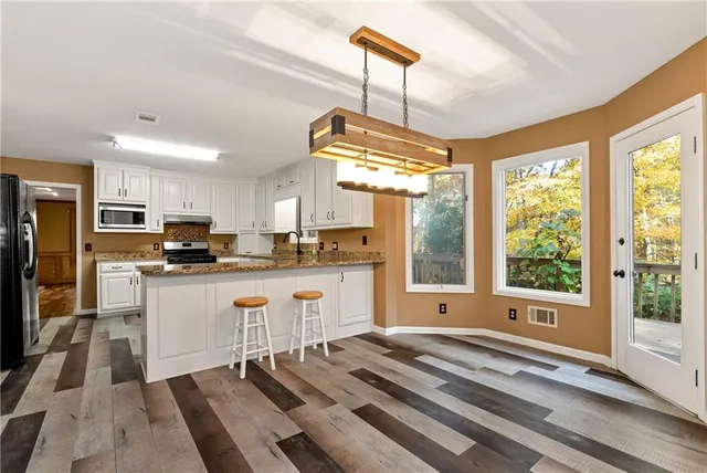 a view of room with window and wooden floor