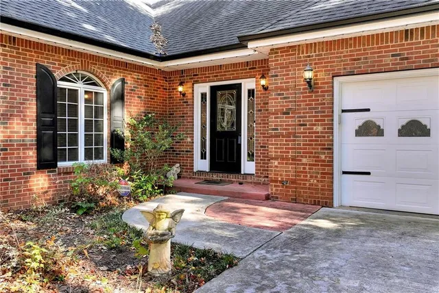 front view of a house with a tree