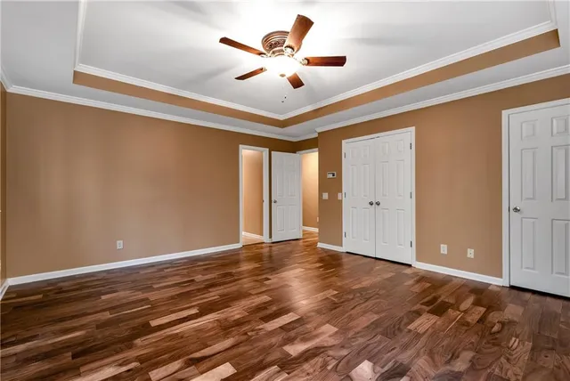an empty room with a ceiling fan and chandelier fan