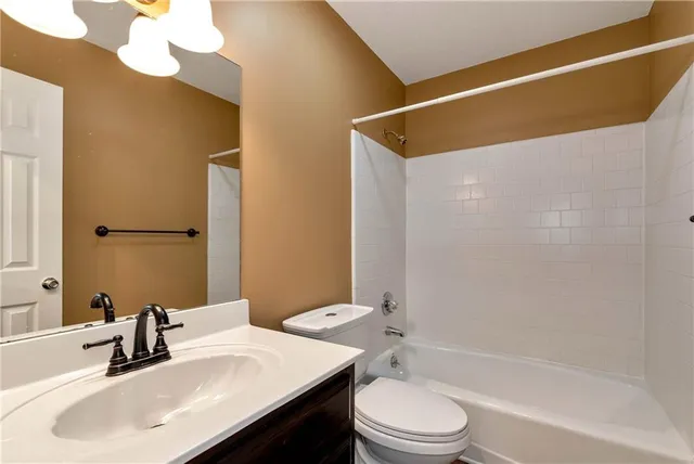 a spacious bedroom with a bed and a window