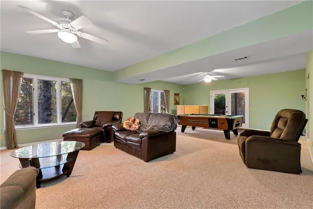 a view of an empty room and a ceiling fan