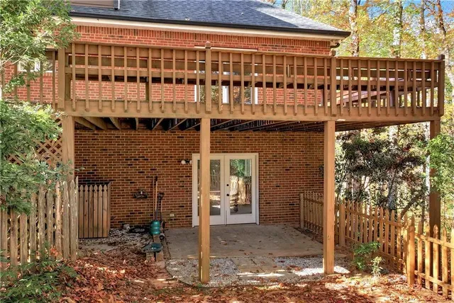 a view of balcony with wooden floor and fence