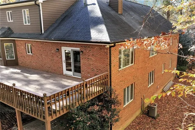 a backyard of a house with table and chairs
