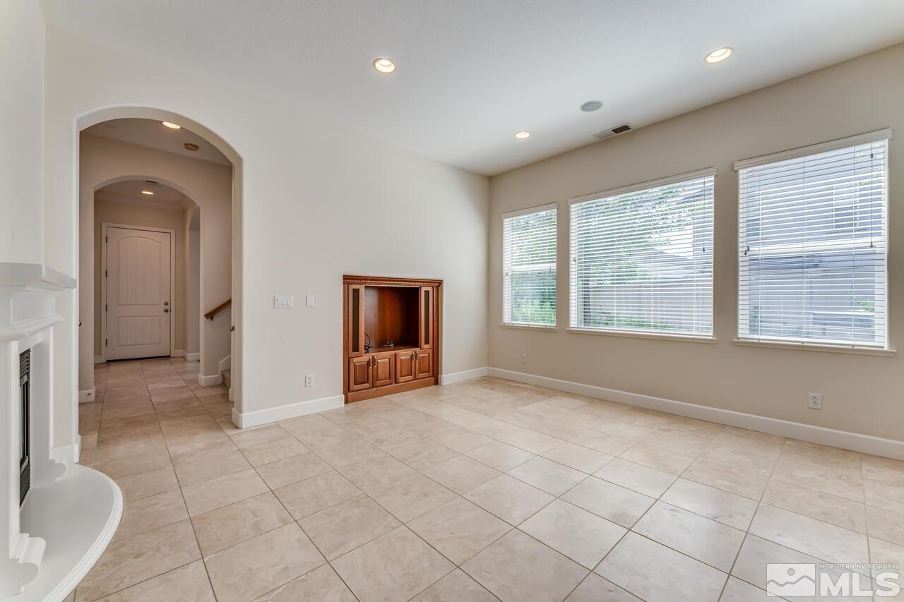 7625 Stone Bluff Way Reno, NV 89523 - Photo 11 of 32 a view of an empty room with a fireplace and a window
