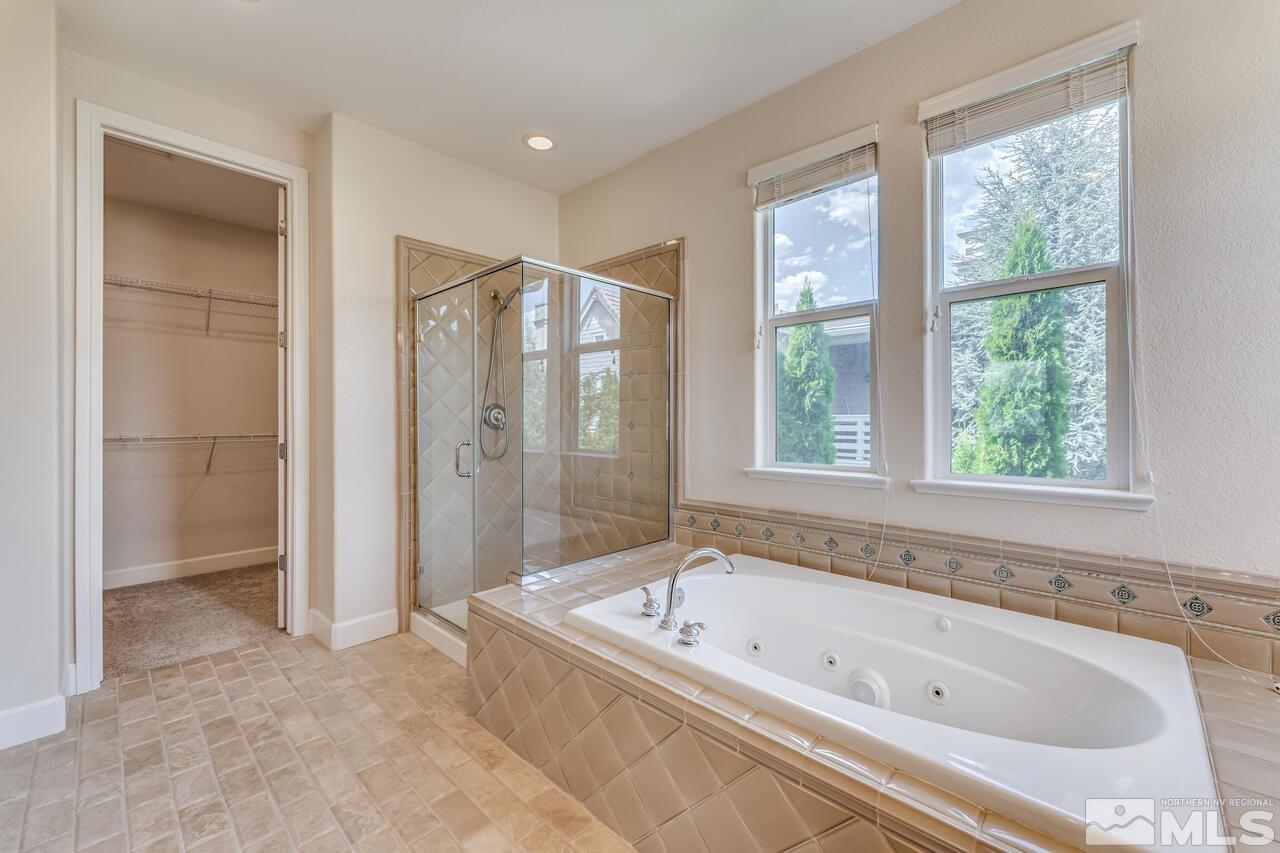 7625 Stone Bluff Way Reno, NV 89523 - Photo 23 of 32 a bathroom with a bathtub and a shower