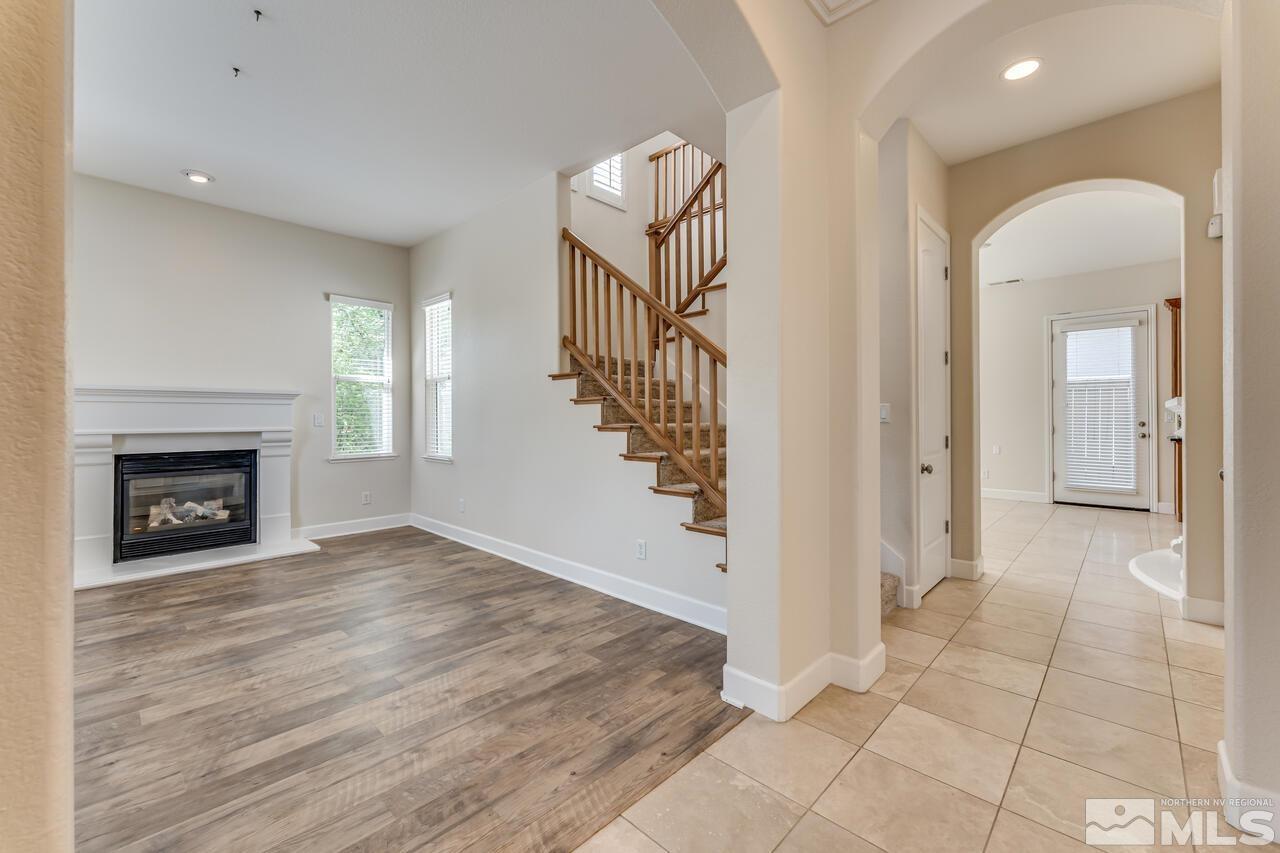 7625 Stone Bluff Way Reno, NV 89523 - Photo 3 of 32 a view of a livingroom with wooden floor and a fireplace