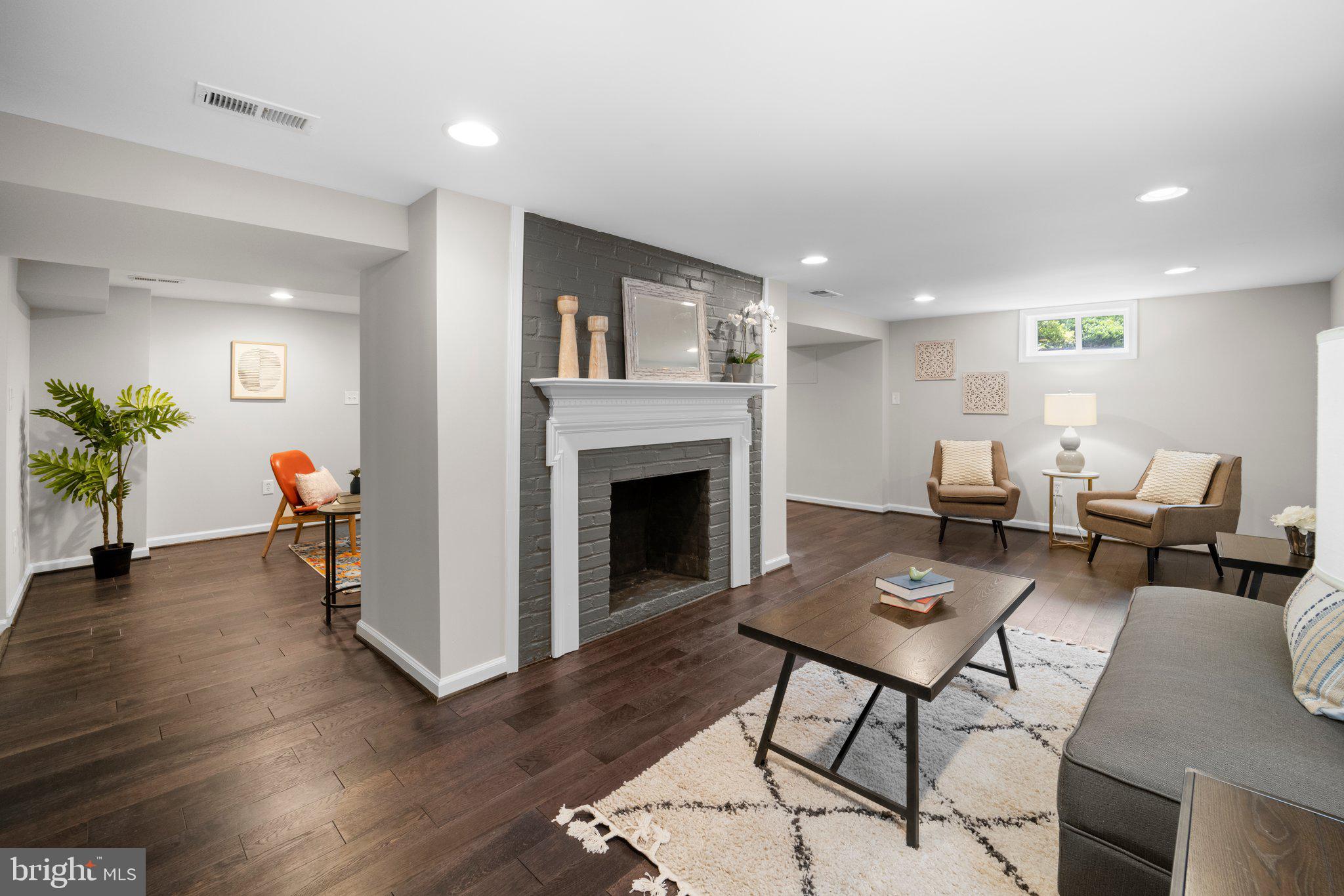 1812 Florin Street Silver Spring, MD 20902 - Photo 27 of 38 a living room with furniture a fireplace and a table