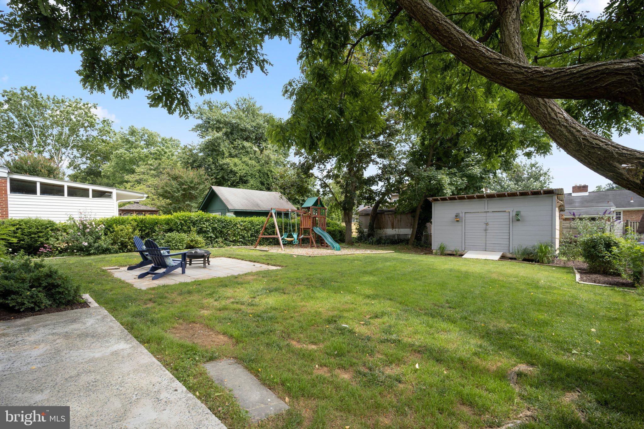 1812 Florin Street Silver Spring, MD 20902 - Photo 32 of 38 a view of a backyard with table and chairs and a large tree