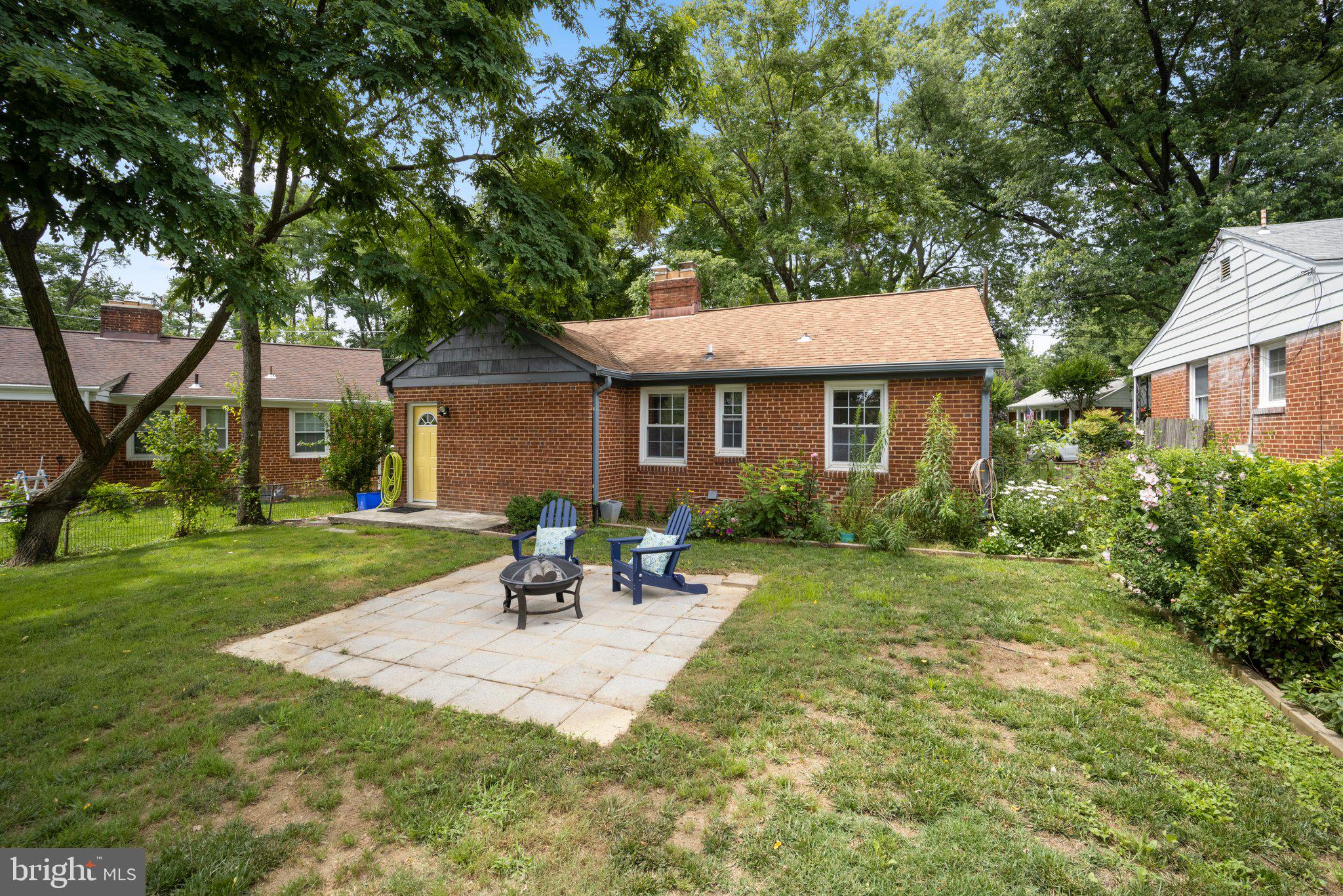 1812 Florin Street Silver Spring, MD 20902 - Photo 34 of 38 a porch with a table and chairs under an umbrella