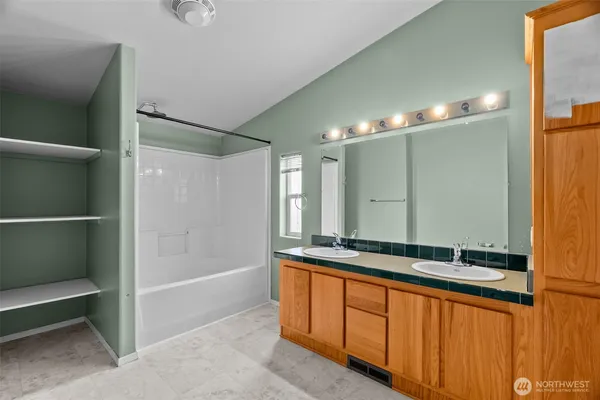 a bathroom with a double vanity sink and a mirror