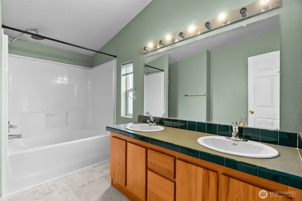 a bathroom with a double vanity sink and a mirror