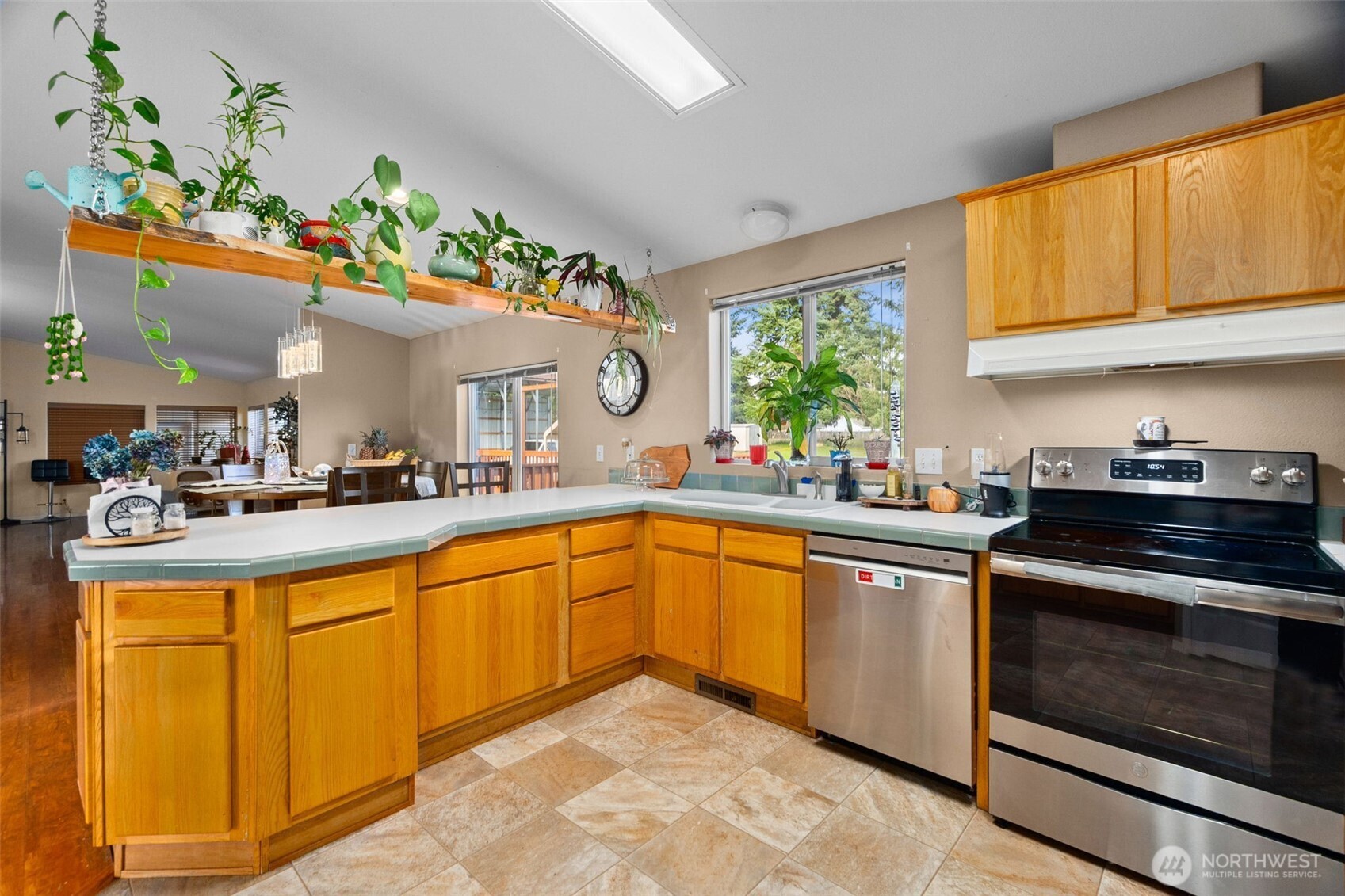 7808 197th Avenue Southwest Rochester, WA 98579 - Photo 7 of 37 a kitchen with stainless steel appliances granite countertop a stove a sink and a microwave