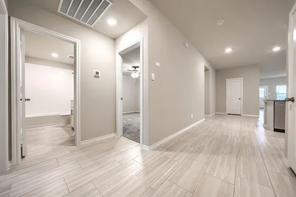 a view of a big room with wooden floor and windows
