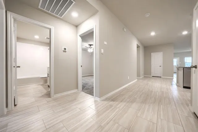 a view of a big room with wooden floor and windows