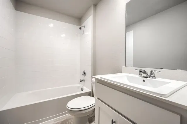 a bathroom with a sink a toilet and a bathtub
