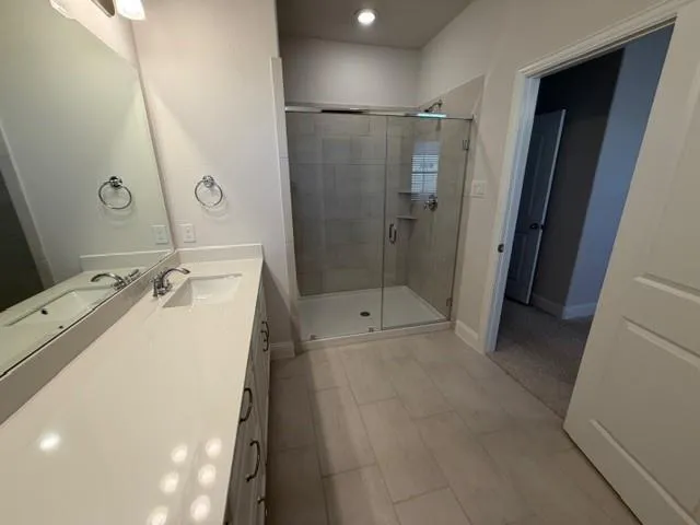 a bathroom with a tub sink and shower