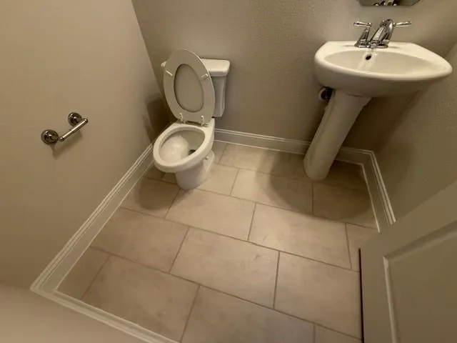 a bathroom with a sink toilet and a mirror