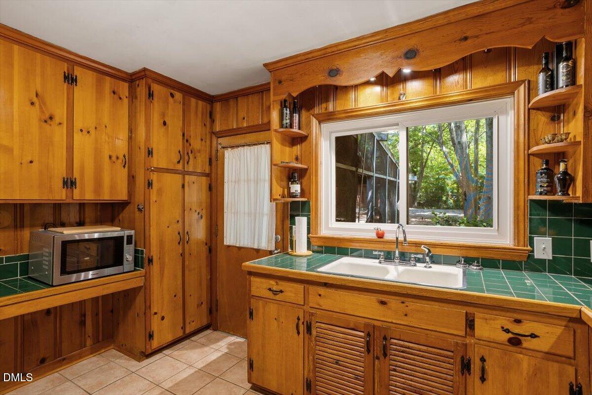 3107 Dixon Road Durham, NC 27707 - Photo 15 of 35 a bathroom with a sink a mirror and next to a window
