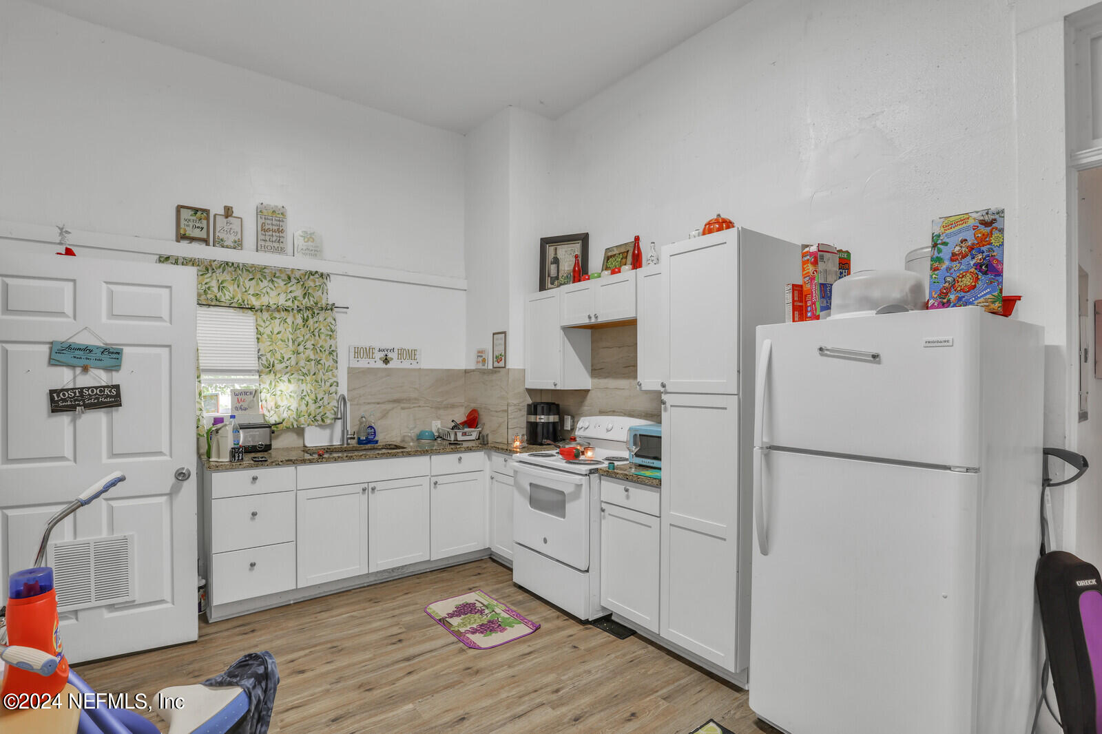 2306 Moncrief Road Jacksonville, FL 32209 - Photo 14 of 14 a kitchen with a white cabinets and white appliances