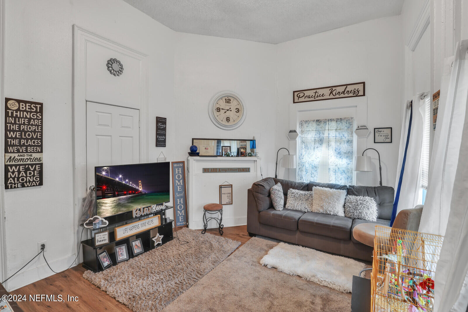 2306 Moncrief Road Jacksonville, FL 32209 - Photo 9 of 14 a living room with furniture a flat screen tv and a fireplace