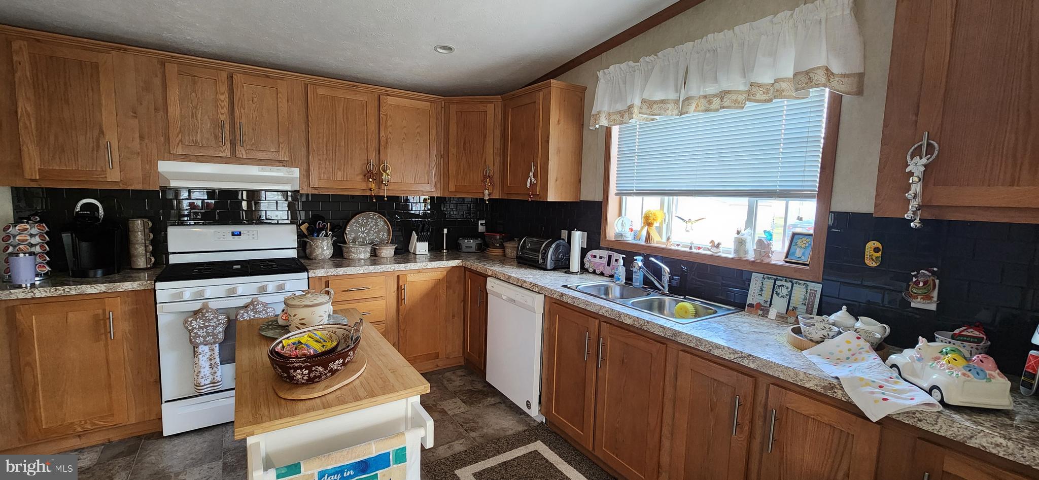 77 Pine Ridge Boulevard Whiting, NJ 08759 - Photo 23 of 49 a kitchen with a refrigerator and a stove top oven