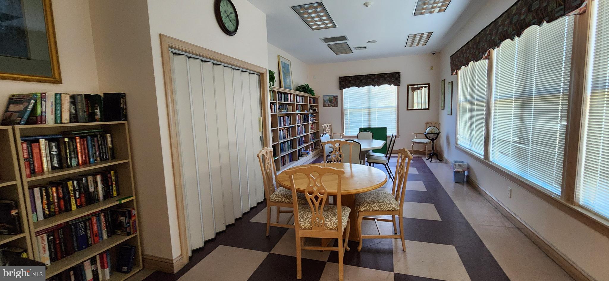 77 Pine Ridge Boulevard Whiting, NJ 08759 - Photo 39 of 49 a dining room with furniture and a book shelf