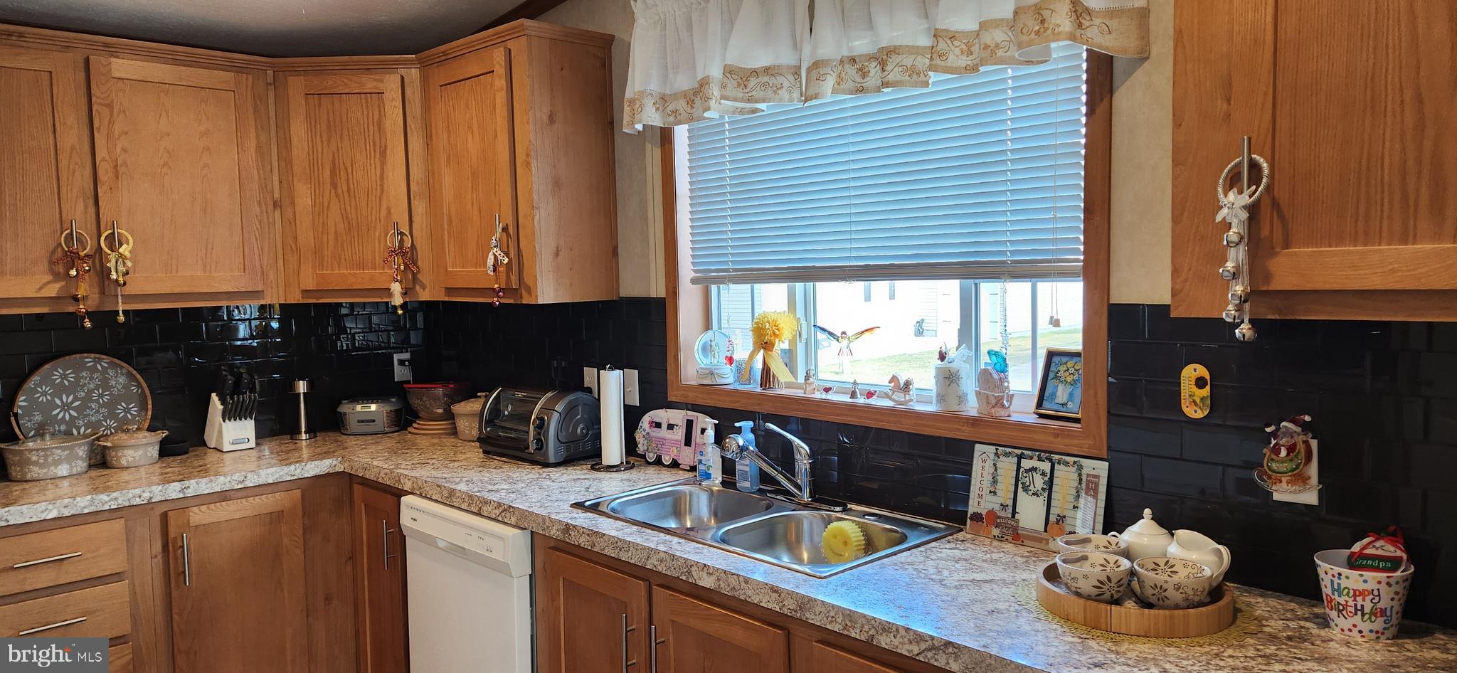 77 Pine Ridge Boulevard Whiting, NJ 08759 - Photo 4 of 49 a kitchen with a sink and wooden cabinets