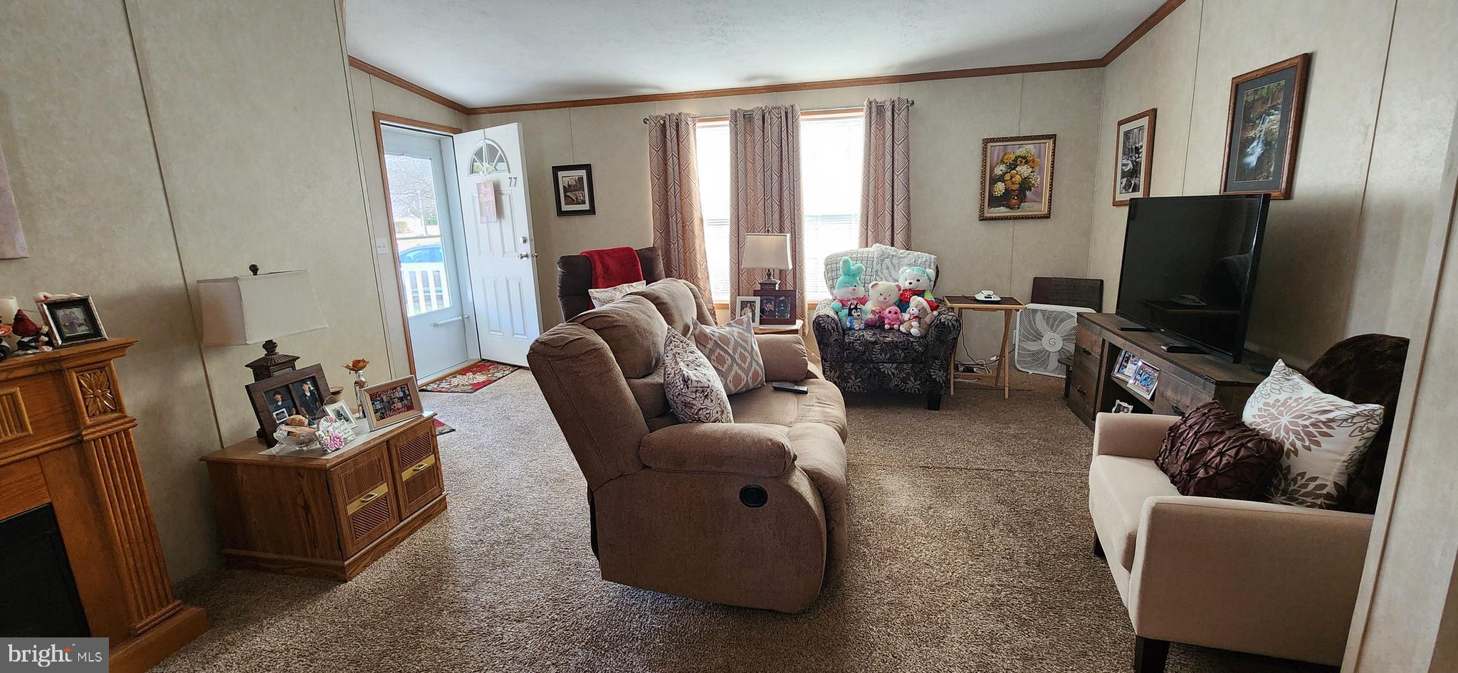 77 Pine Ridge Boulevard Whiting, NJ 08759 - Photo 6 of 49 a living room with furniture a flat screen tv and a window