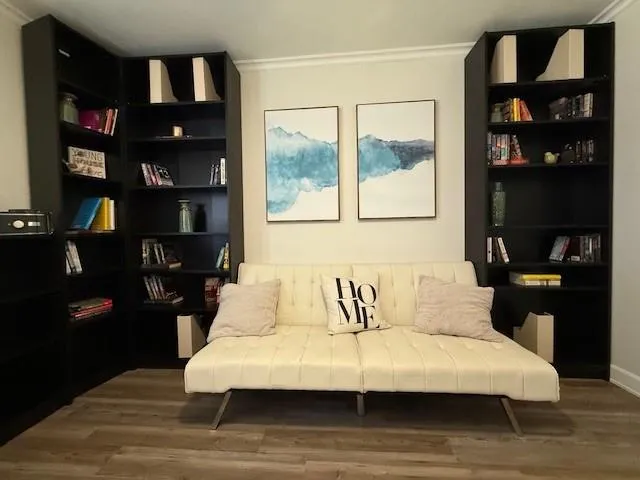 a bedroom with a bed and a book shelf