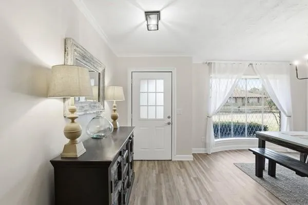 a view of a dining room with furniture and wooden floor