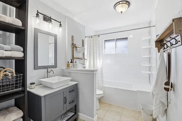 a bathroom with a sink toilet double vanity and shower