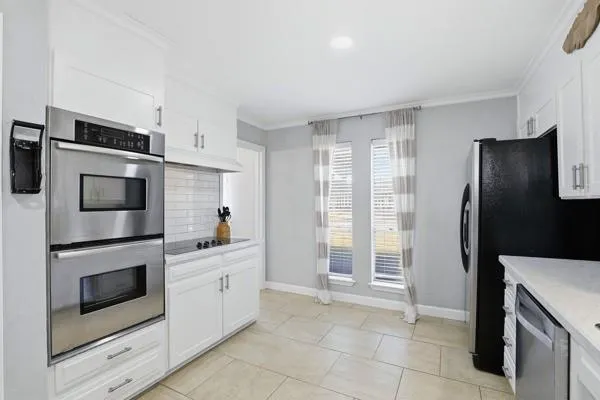 a kitchen with stainless steel appliances a refrigerator sink and cabinets