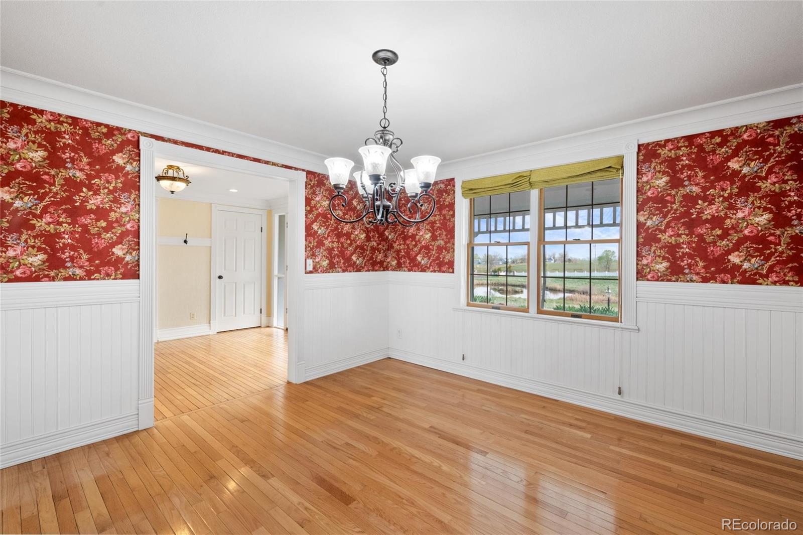 6231 Prospect Road Longmont, CO 80503 - Photo 12 of 45 wooden floor in an empty room with a window