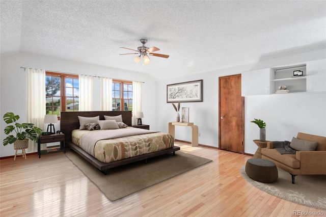 a spacious bedroom with a bed and furniture