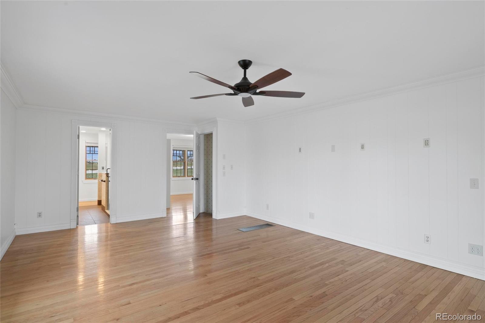 6231 Prospect Road Longmont, CO 80503 - Photo 19 of 45 a view of an empty room with window and wooden floor