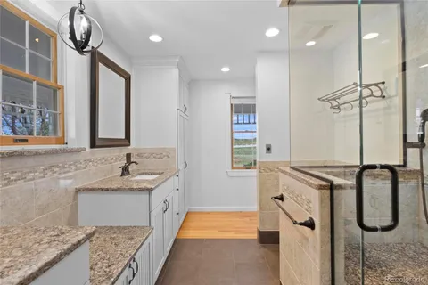 a bathroom with double vanity sink and a mirror