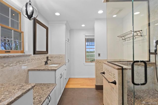 a bathroom with double vanity sink and a mirror